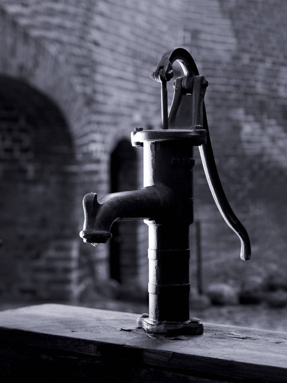 Black and white picture of a traditional hand well pump.