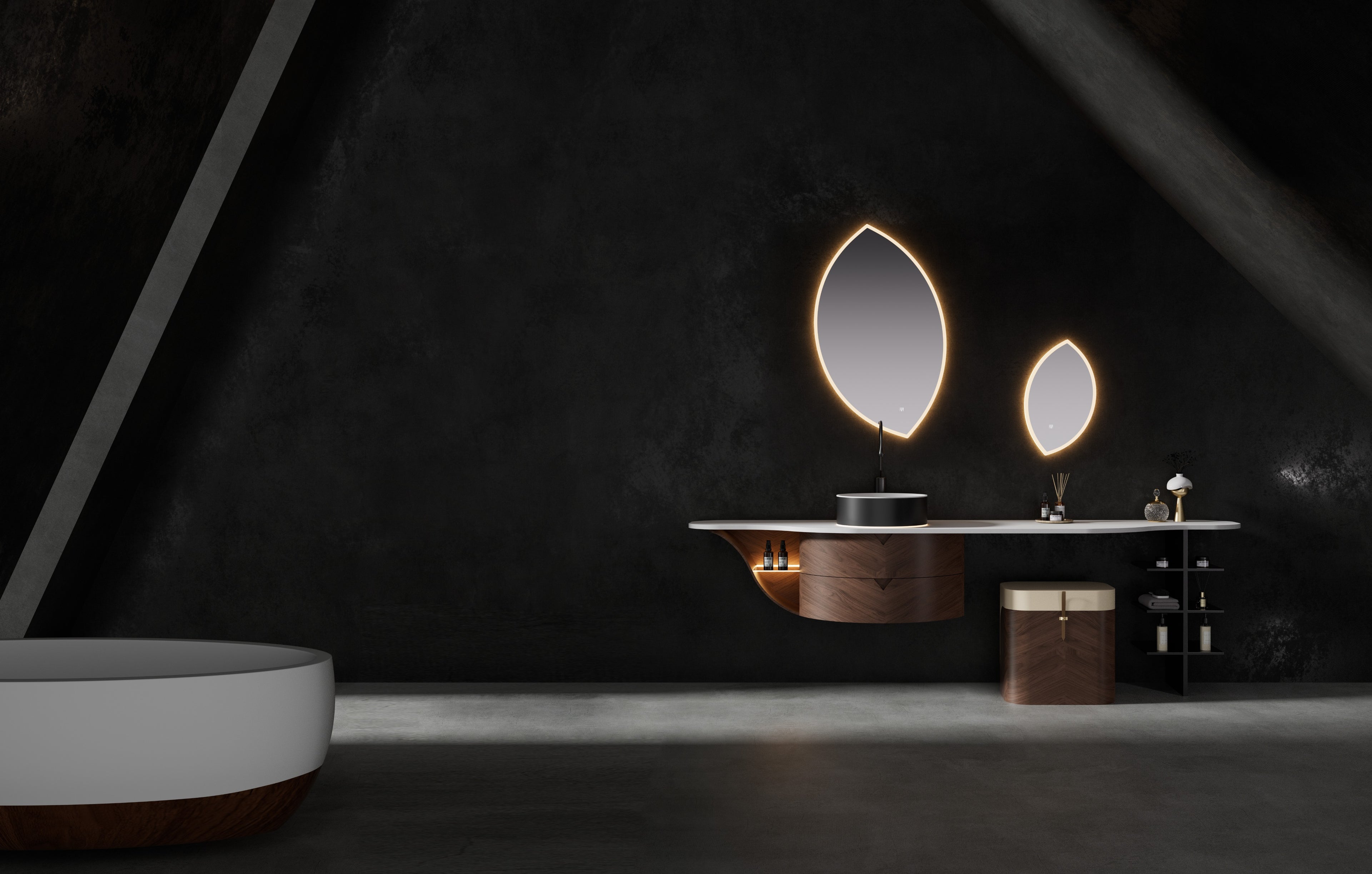 Arcana by Brandt floating wall-hung bathroom vanity featuring a single walnut cabinet with curved drawer fronts, curved side shelf, integrated vanity table with walnut and leather dressing stool, white sintered stone countertop with illuminated gunmetal vessel basin, leaf-shaped led-mirrors, and matching freestanding bathtub.